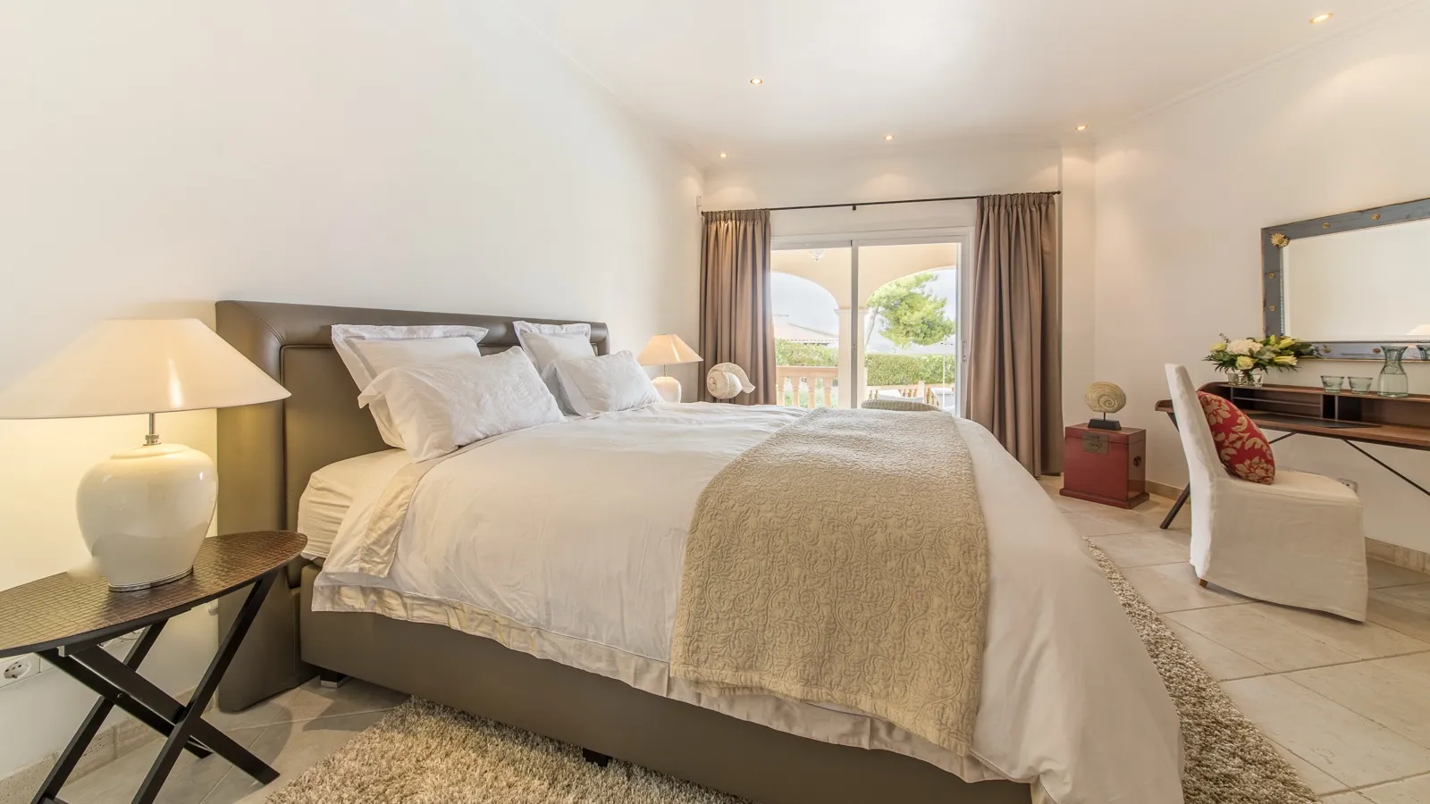 One of the four bedrooms, quiet in the afternoon light